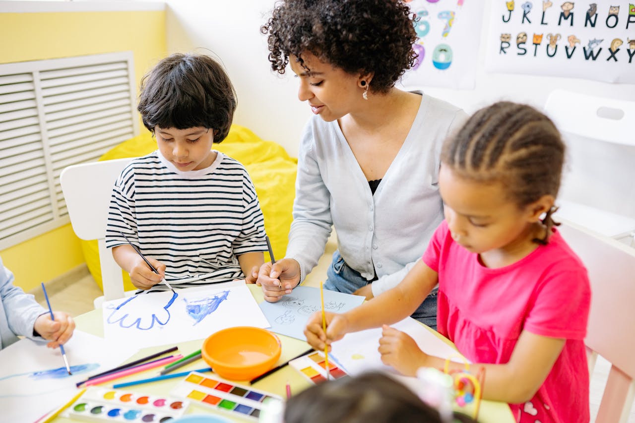Children painting with watercolors in a classroom