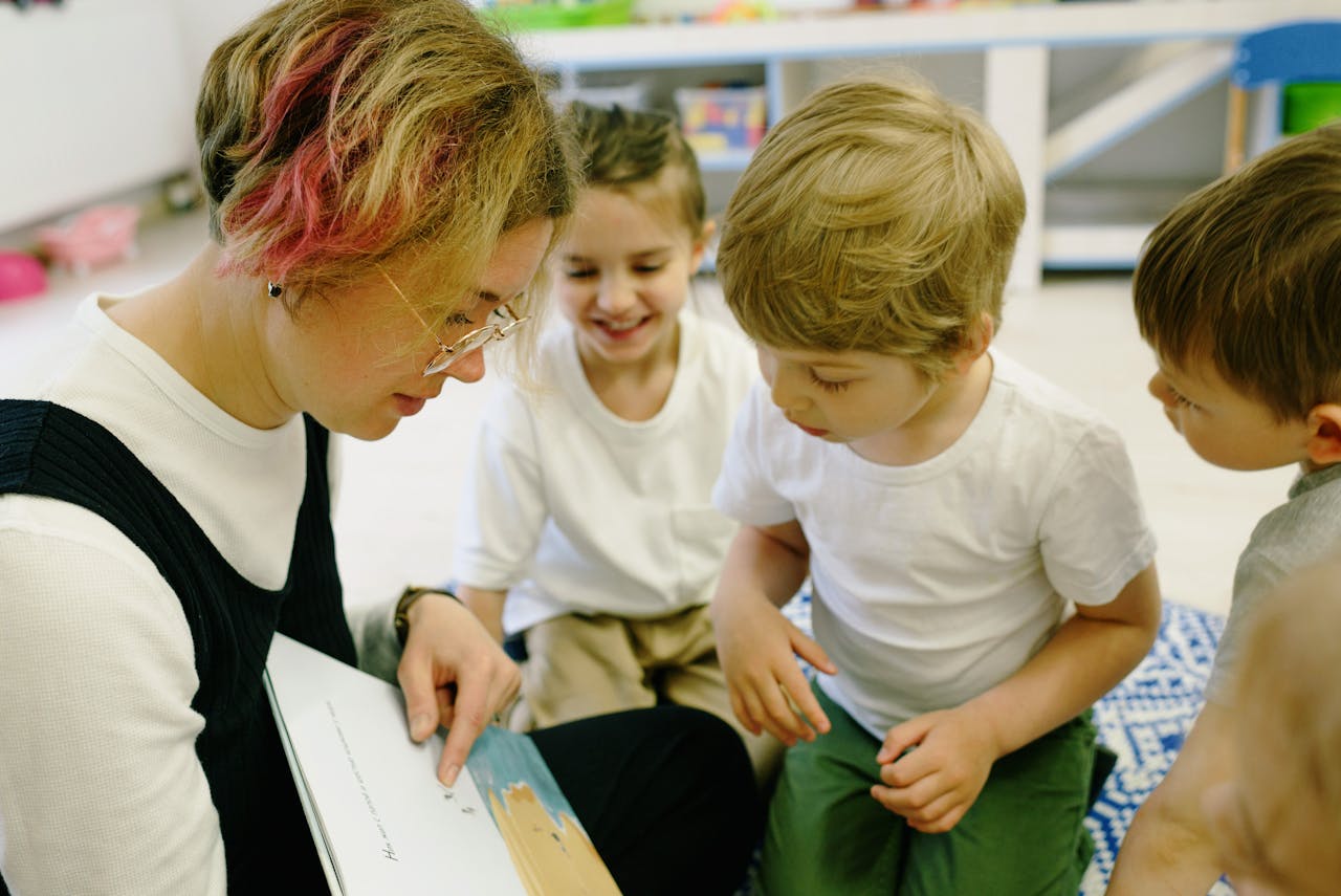 Educator teaching children to read in a warm classroom